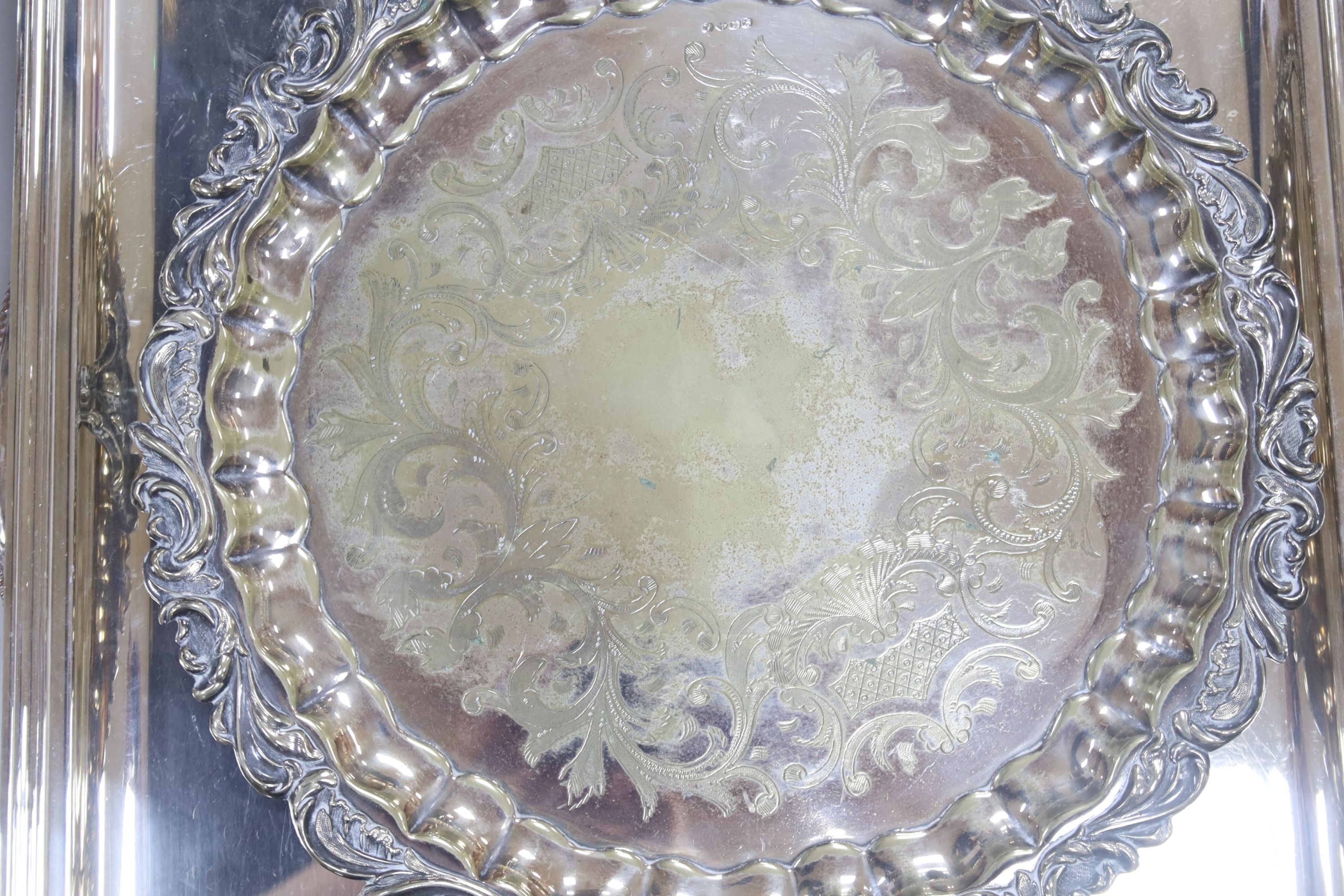 A plated oval tray, a rectangular tray, overall width 67cm, and a plated salver